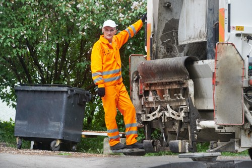 Workers sorting recyclable materials at a Chertsey clearance site